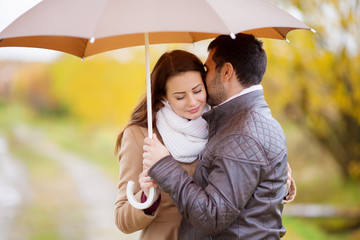 Couple of lovers under umbrella in the rain