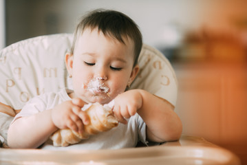 baby in the kitchen eagerly eating the delicious cream horns, filled with a vanilla cream