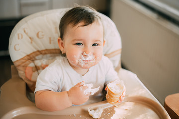 baby in the kitchen eagerly eating the delicious cream horns, filled with a vanilla cream