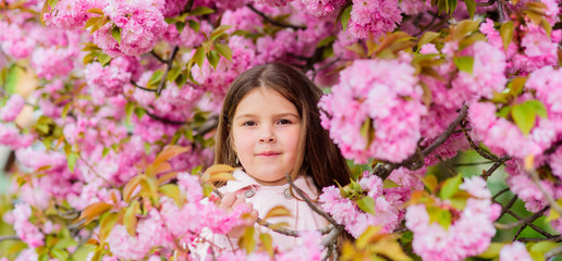 Child enjoy life without allergy. Sniffing flowers. Get rid of seasonal allergy. Girl enjoying...