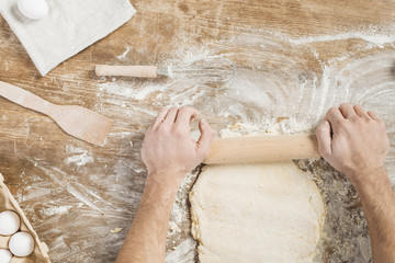 Top view of man making pizza dough