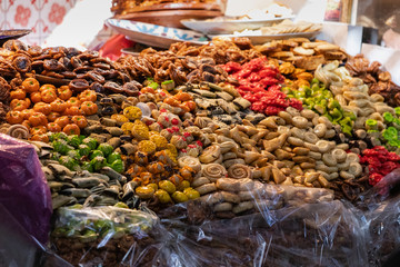 Bees over a street food stand of sweet delights in Marrakesh, Morocco