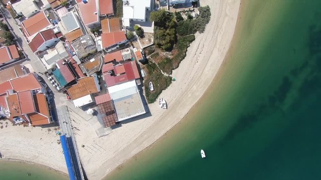 Top View flying over the seashore on the Armona Island. Drone shot from the sea to the land.