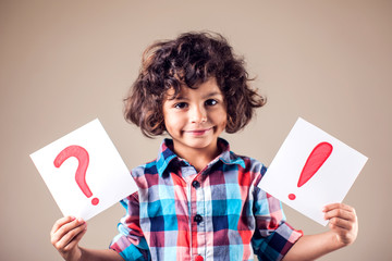 Thinking kid boy with question and exclamation signs