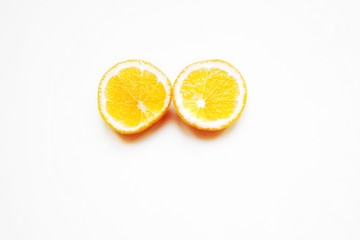 two round oranges cut on a light background, minimalism, close-up, selective focus, copy space