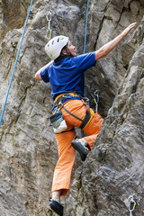 Female climber scaling rock face, Sautens, Otztal, Tyrol, Austria