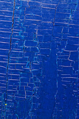 Old wooden background with remains of pieces of scraps of old paint on wood. Texture of an old tree, vintage wood background peeling paint. old blue board with cracked paint