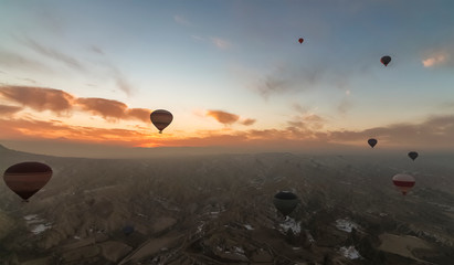 Aerial view of Cappadocia at sunrise with hot air balloons