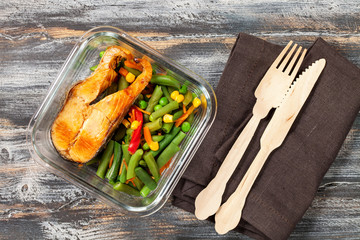 Healthy Meal  containers with grilled salmon fish