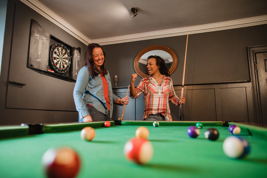 Competitive Friends Playing Pool