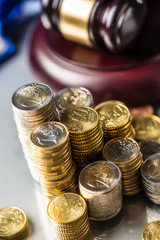 Towers with euro coins and justice hammer in the background