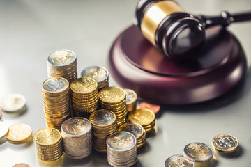 Towers with euro coins and justice hammer in the background