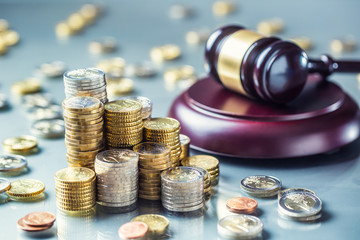 Towers with euro coins and justice hammer in the background