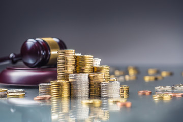 Towers with euro coins and justice hammer in the background