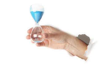 Male hand holding an sand hour glass on white background.