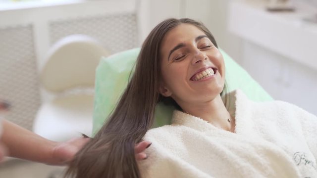 Hair Mesotherapy Doctor Spraying Hair of Young Caucasian Female Patient as Part of Mesotherapy Treatment. Light Camera Movement