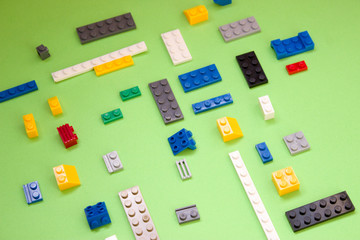 Background for children's site, for the menu. Children's constructors on green. Multi-colored cubes. Games for motor developing memory and mind.