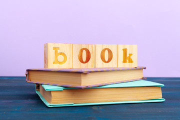 cube wooden block with alphabet building the word book