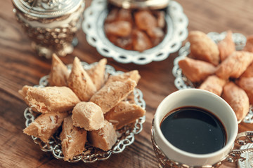Turkish sweets with coffee on a wooden table