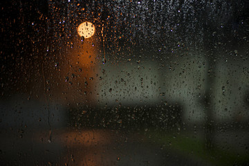 Rain drops on the car glass in the night.