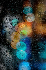  Rainy day. Raindrops on a blurred multicolored bokeh background