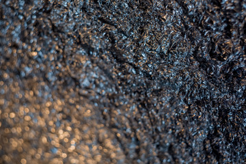 Background with blurry gradient of dark silver crumpled foil. Art photography. Toned image doesn’t in focus. Abstract blur pattern for poster, print. Macro. Soft focus.