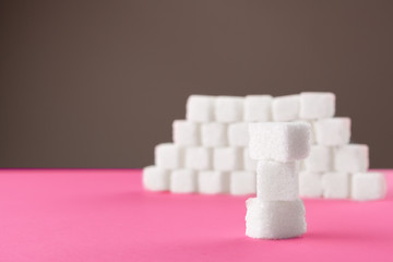 Cubes of sugar on a pink background. Empty space for copying text