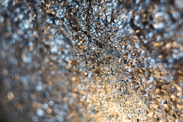 Background with blurry gradient of dark silver crumpled foil. Art photography. Toned image doesn’t in focus. Abstract blur pattern for poster, print. Macro. Soft focus.