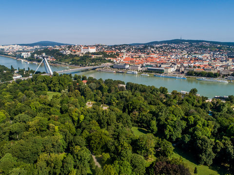 Aerial view of Slovakia capital city Bratislava with its sights. Bridge of Slovak National Uprising, UFO restaurant, Bratislava castle, and the oldest public park in central Europe - Janko Kral Park.