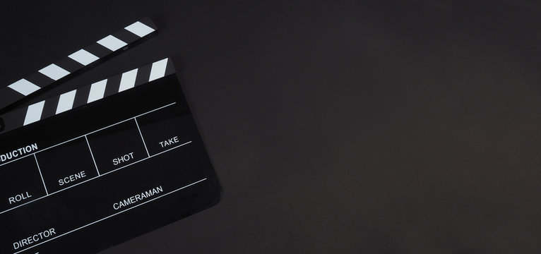 Black Clapperboard or clap board or movie slate use in video production ,film, cinema industry on black background.