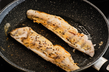 Cooking zander fillet on frying pan