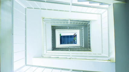 Apartment stairway in the middle looking up