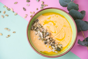 homemade Warm pumpkin soup with pumpkin seeds and cream