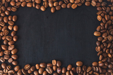  Coffee beans in a black wooden background.