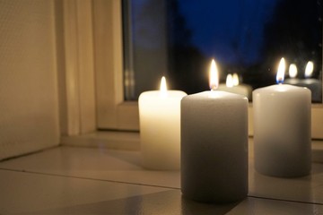 Fototapeta na wymiar candles in window at night