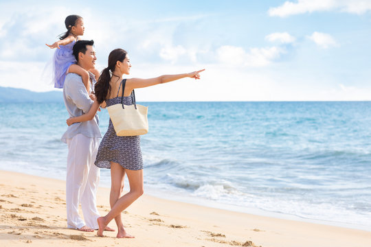Happy young family by the sea