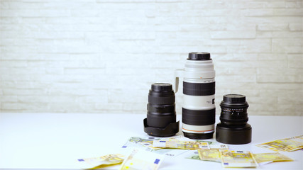 Money lying around an expensive photography lenses