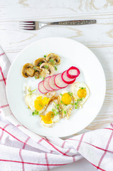 Healthy breakfast with quail eggs, radish, mushrooms and microgreens. Diet on a plate