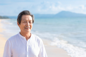 Happy senior man on beach