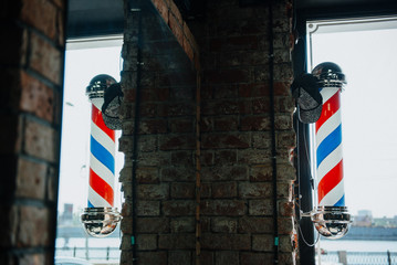 Old fashioned vintage glass Barber Shop pole with Barber Sign