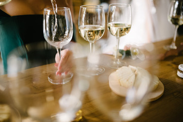 Man pours champagne into a glass from a bottle