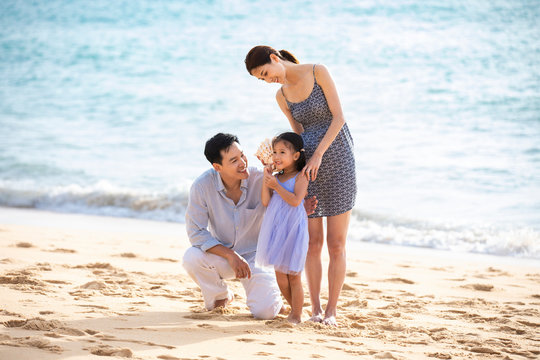 Happy young family having fun on beach