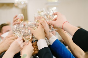 People clink glasses at the holiday close-up
