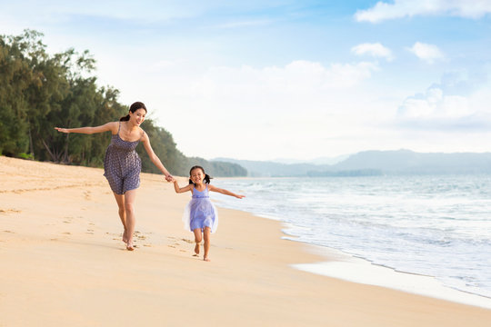 Happy mother and daughter on beach