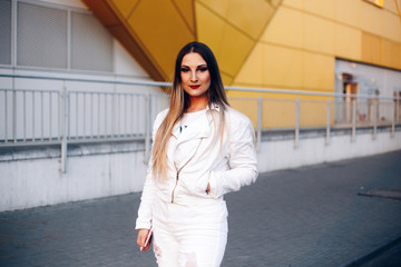 Beautiful woman in white clothes with wonderful makeup. On yellow and white background.