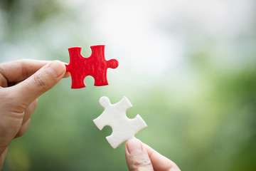 Hand connect white and red jigsaw parts with word problem & solution.   symbol of association and...