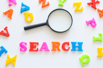Word Search and magnifying glass on the light background.