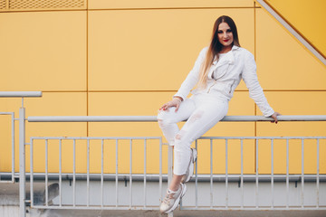 Beautiful woman in white clothes with wonderful makeup. On yellow and white background.