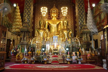 altar and statues of buddha in a buddhist temple (Wat Phra That Haripunchai) in Lamphun (Thailand)