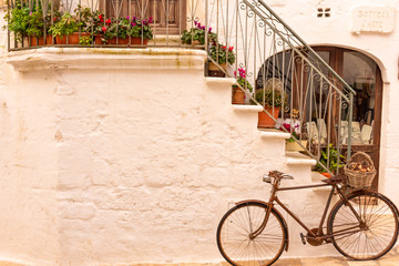 Italy, Ostuni, old bicycle leaning against the wall, for tourists.